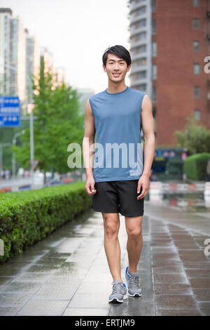 Young man doing exercise outside Stock Photo