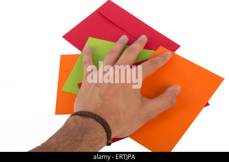 Close up top view of man hand holding multicolored envelopes, isolated on white background. Stock Photo