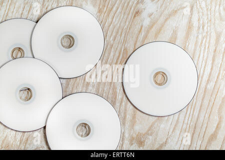 Blank printable CD and DVD on light wooden background. Top view. Stock Photo