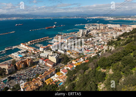 View of Gibraltar cityscape, Gibraltar, Europe from the top of the Rock of Gibraltar in summer with the harbour and coast Stock Photo