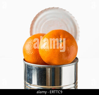 Oranges / satsumas fruit heaped inside opened tin can - fresh food coming in cans concept Stock Photo