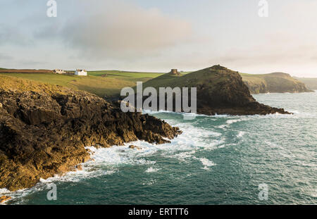 Doyden Castle on the cliffs at Port Quin near Port Issac, Atlantic coast, North Cornwall, UK in the late afternoon light Stock Photo