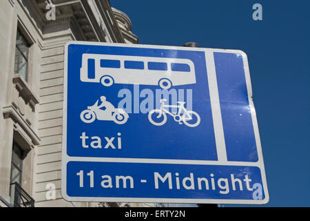 british road sign indicating road lane restrictions and times of operation Stock Photo