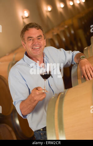 Man tasting wine in cellar, Saint-Emilion, Bordeaux Wineyard, France, Stock Photo