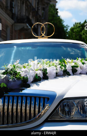 White wedding limousine decorated with flowers Stock Photo