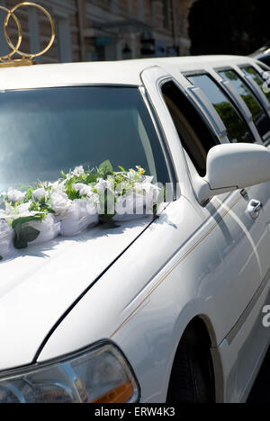 White wedding limousine decorated with flowers Stock Photo