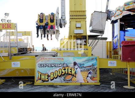 Brighton UK June 2015 - People enjoy the Booster fairground ride on Brighton Pier formerly known as the Palace Pier Stock Photo