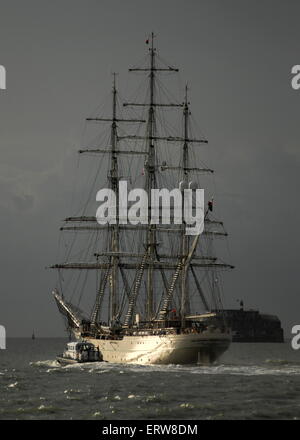 AJAXNETPHOTO. 8TH OCTOBER, 2014. PORTSMOUTH, ENGLAND. - TRAINING SHIP DEPARTS - THE OMANI NAVAL TALL SHIP STV SHABAB OMANI 2 LEAVES PORTSMOUTH UNDER DRAMATIC SKIES. PHOTO:TONY HOLLAND/AJAX REF:DTH140810 1199 Stock Photo
