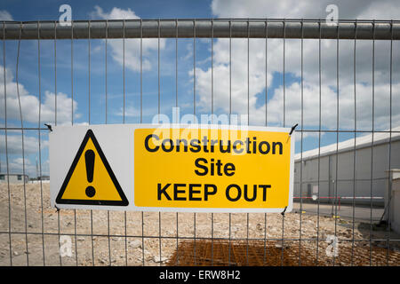 construction site keep out sign on the fence of a building site Stock Photo