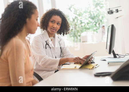 Doctor and patient using digital tablet in office Stock Photo