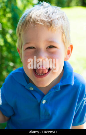 blond boy smiling with dirty face Stock Photo