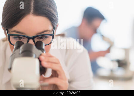 Scientist using microscope in research laboratory Stock Photo