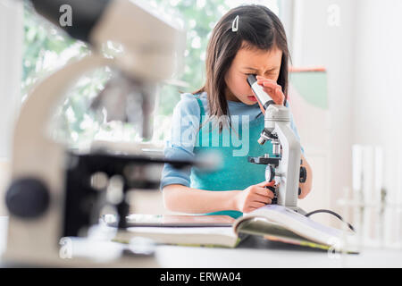 Chinese student using microscope in science lab Stock Photo