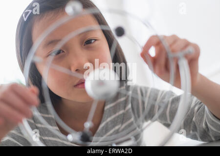 Chinese student examining molecular model Stock Photo