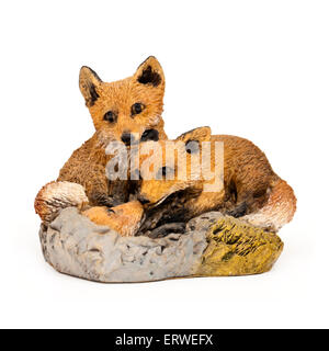 Handpainted ornament of a pair of foxes looking after their cub Stock Photo