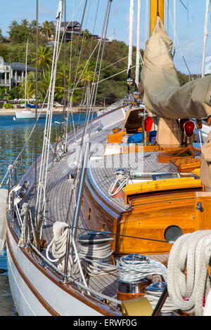 Classic yacht moored in Falmouth, Antigua with villas in the background Stock Photo