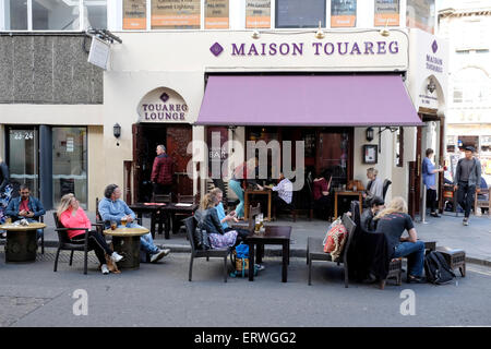 People sitting outside a restaurant in Soho, London Stock Photo