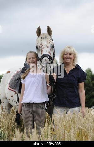 women and Tiger Horse Stock Photo