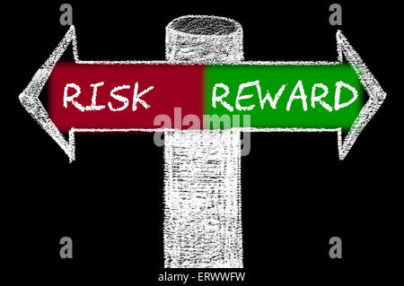 Opposite arrows with Risk versus Reward. Hand drawing with chalk on blackboard. Choice conceptual image Stock Photo