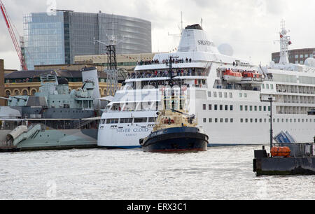 London, UK. 08th June, 2015. Tug moving MV Silver Cloud from her berth next to HMS Belfast on the River Thames London UK last evening. The cruise ship was manoeuvred in reverse through Tower Bridge using two tugs Svitzer Cecilia and Svitzer Brunel. Credit:  Peter Titmuss/Alamy Live News Stock Photo
