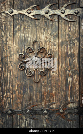 old rusty decorative element and wood door. Background for design Stock Photo