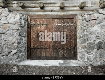 Wooden old door with lock and granite wall. Background for design Stock Photo