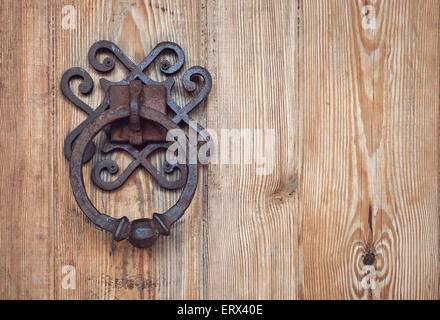 old rusty doorknob and wood door.  Background for design Stock Photo