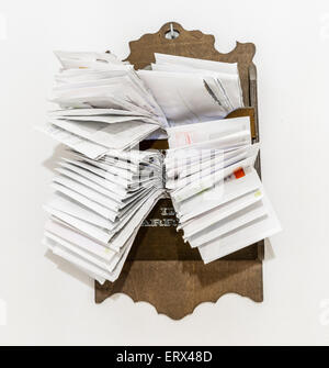 bunches of old bills and accounts  in dusty original envelopes collected in wood support Stock Photo