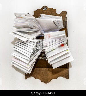 bunches of old bills and accounts  in dusty original envelopes collected in wood support Stock Photo