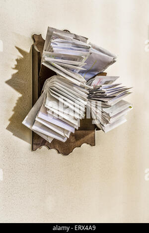 bunches of old bills and accounts  in dusty original envelopes collected in wood support Stock Photo