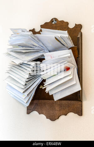 bunches of old bills and accounts  in dusty original envelopes collected in wood support Stock Photo