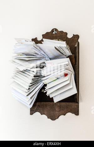 bunches of old bills and accounts  in dusty original envelopes collected in wood support Stock Photo