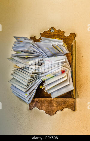 bunches of old bills and accounts  in dusty original envelopes collected in wood support Stock Photo