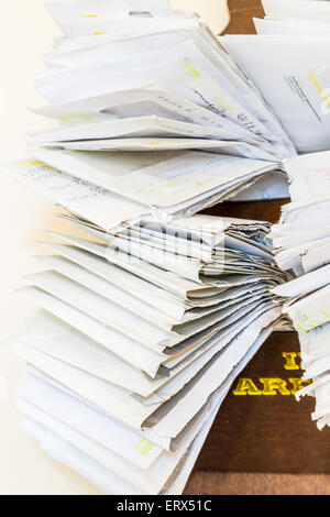 bunches of old bills and accounts  in dusty original envelopes collected in wood support Stock Photo