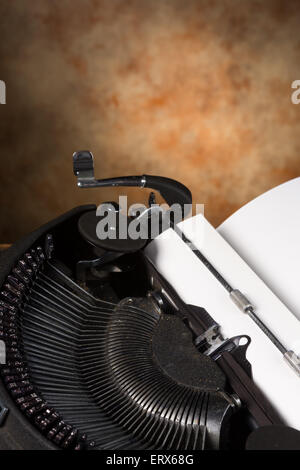 Dusty old antique typewriter with a blank page in it Stock Photo