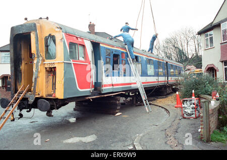 Purley  train crash On 4 March 1989 the 12:50 from Horsham stopped at Purley railway station. As it left the station, it crossed from the slow line to the fast line as scheduled and at 13:39 was struck from behind by the following 12:17 from Littlehampton, The first six coaches of the Littlehampton train left the track and rolled down the embankment, killing 5 passengers and injuring 88. Our Picture Shows: The recovery of the carriages of the Littlehampton train from the embankment Stock Photo