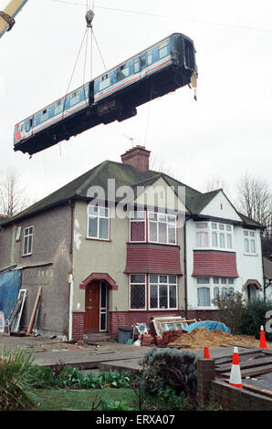 Purley  train crash On 4 March 1989 the 12:50 from Horsham stopped at Purley railway station. As it left the station, it crossed from the slow line to the fast line as scheduled and at 13:39 was struck from behind by the following 12:17 from Littlehampton, The first six coaches of the Littlehampton train left the track and rolled down the embankment, killing 5 passengers and injuring 88. Our Picture Shows: The recovery of the carriages of the Littlehampton train from the embankment Stock Photo