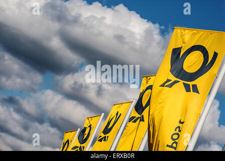 Berlin, Germany. 09th June, 2015. Deutsche Post flags wave in front of the mail center in Berlin, Germany, 09 June 2015. The Verdi labor union have called Deutsche Post employees to an open-ended strike. Photo: PAUL ZINKEN/dpa/Alamy Live News Stock Photo