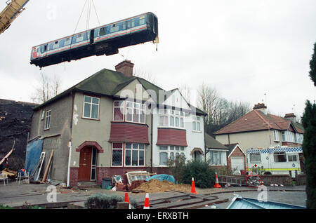 Purley  train crash On 4 March 1989 the 12:50 from Horsham stopped at Purley railway station. As it left the station, it crossed from the slow line to the fast line as scheduled and at 13:39 was struck from behind by the following 12:17 from Littlehampton, The first six coaches of the Littlehampton train left the track and rolled down the embankment, killing 5 passengers and injuring 88. Our Picture Shows: The recovery of the carriages of the Littlehampton train from the embankment Stock Photo