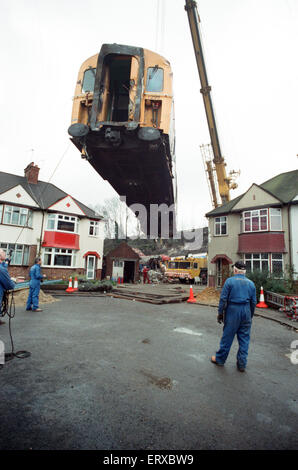 Purley  train crash On 4 March 1989 the 12:50 from Horsham stopped at Purley railway station. As it left the station, it crossed from the slow line to the fast line as scheduled and at 13:39 was struck from behind by the following 12:17 from Littlehampton, The first six coaches of the Littlehampton train left the track and rolled down the embankment, killing 5 passengers and injuring 88. Our Picture Shows: The recovery of the carriages of the Littlehampton train from the embankment Stock Photo