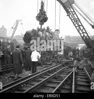 The Harrow and Wealdstone rail crash was a three train collision at Harrow and Wealdstone station in London at 8:19 am on 8 October 1952. An express train from Perth Scotland colided at speed into the rear of the Tring to Euston local service passenger train that had stopped at the station; within a few seconds of this collision the Euston to Liverpool express train travelling at speed in the opposite direction crashed into the Perth train's locomotive. It was the worst peacetime rail crash in the United Kingdom there were 112 fatalities. Our Picture Shows: The remains of one of the steam Stock Photo