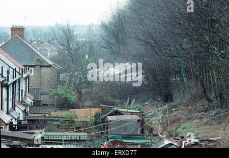 Purley  train crash On 4 March 1989 the 12:50 from Horsham stopped at Purley railway station. As it left the station, it crossed from the slow line to the fast line as scheduled and at 13:39 was struck from behind by the following 12:17 from Littlehampton, The first six coaches of the Littlehampton train left the track and rolled down the embankment, killing 5 passengers and injuring 88. Our Picture Shows: Carriages laying on their side along the embankment Stock Photo