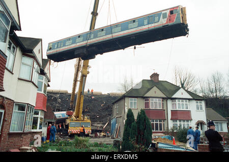 Purley  train crash On 4 March 1989 the 12:50 from Horsham stopped at Purley railway station. As it left the station, it crossed from the slow line to the fast line as scheduled and at 13:39 was struck from behind by the following 12:17 from Littlehampton, The first six coaches of the Littlehampton train left the track and rolled down the embankment, killing 5 passengers and injuring 88. Our Picture Shows: The recovery of the carriages of the Littlehampton train from the embankment Stock Photo