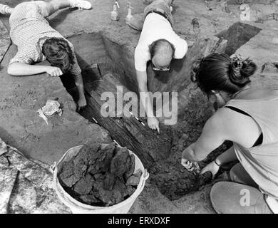 Caldicot Castle, Monmouth, southeast Wales, 29th August 1990. The site of the Glamorgan and Gwent Archaeological Trust dig at Caldicot Castle Country Park. Pictured, workers watering and digging around the 3000 year old boat found in the grounds. They are Samantha Burge, David Williams and Peter Wright (centre). Stock Photo