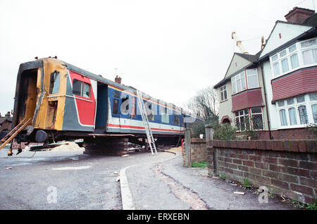 Purley  train crash On 4 March 1989 the 12:50 from Horsham stopped at Purley railway station. As it left the station, it crossed from the slow line to the fast line as scheduled and at 13:39 was struck from behind by the following 12:17 from Littlehampton, The first six coaches of the Littlehampton train left the track and rolled down the embankment, killing 5 passengers and injuring 88. Our Picture Shows: The recovery of the carriages of the Littlehampton train from the embankment Stock Photo