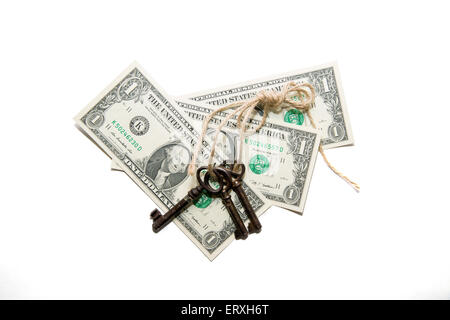 Keys tied with a rope and a few  dollars banknotes on a white background Stock Photo