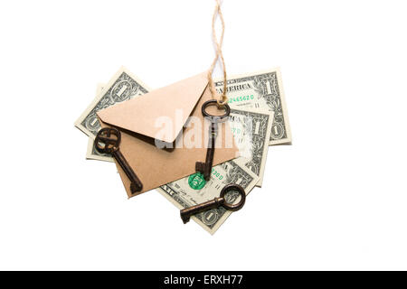 Three old keys, Us dollars  banknotes and envelope on a white background Stock Photo