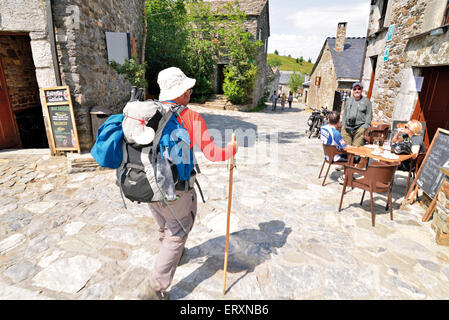 Spain, Galicia: St. James pilgrim arriving in mystic mountain village O Cebreiro meeting his hiking friends Stock Photo