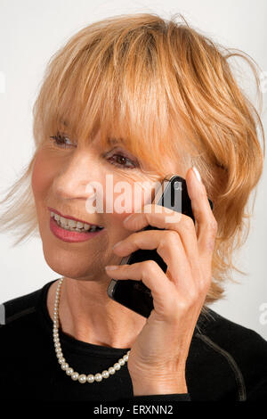 Woman chatting with a close friend on mobile phone Stock Photo