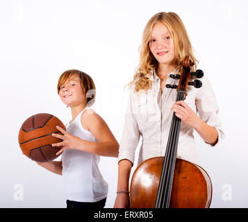 boy with basketball and teenage girl with cello Stock Photo
